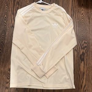 Yellow long sleeve adidas athletic shirt.